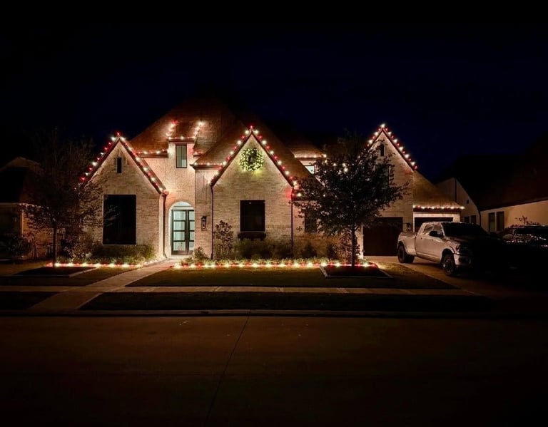 Brick home with red Christmas lights on the ridgeline and a wreath, installed by OnSite Pros in Greater Houston